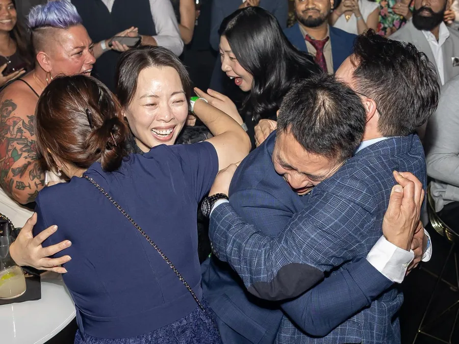 The moment Jinseon was named the winner: the family hugging in the crowd while everyone around them cheers.