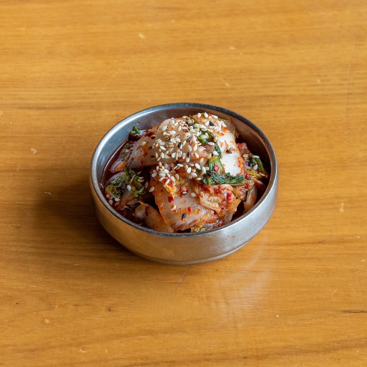 Homemade kimchi in a stainless steel banchan bowl